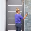 Beautiful woman opening the door of her home.Woman entering the